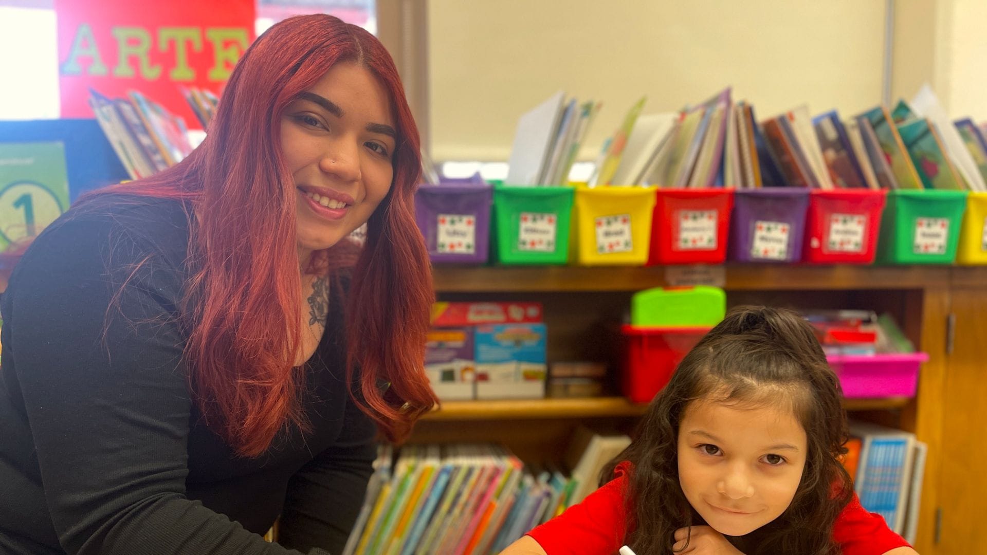 Diana Tirado ‘14, volunteers in the second grade Spanish classroom, helping students practice their writing skills.
